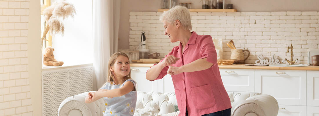 grandparent and child dancing in living room