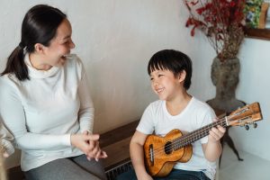 kid playing ukelele