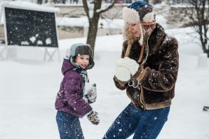 family playing in snow