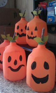 milk jugs painted to look like pumpkins