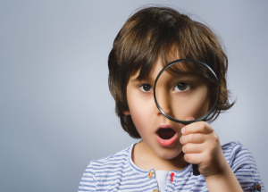 kid holding a magnifying glass