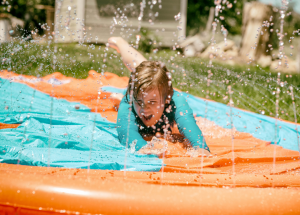 a kid goes down a slip n slide