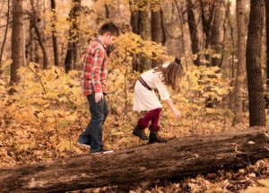 kids walking in the forest in fall