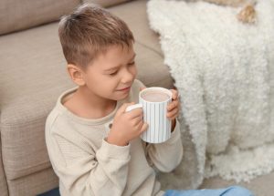 a child drinks hot chocolate